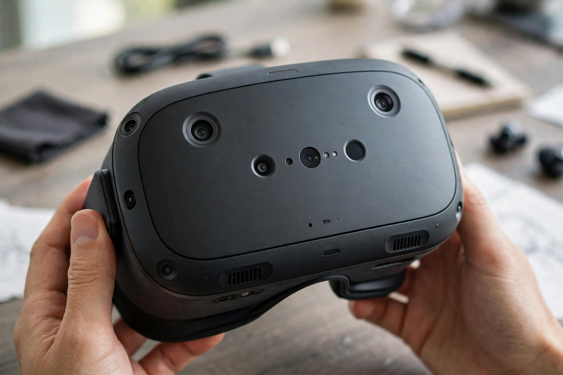 Close-up of the front of a black VR headset showing its tracking cameras and sensors
